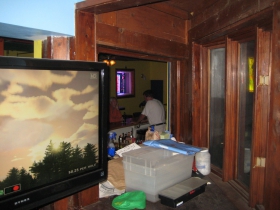 A window niche assembled over the years of who knows what and from who knows where provides a view from the pool room and a handy place of storage while moody skies dominate the video golf course.