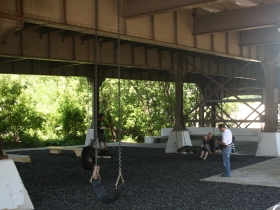 Swings under the bridge.