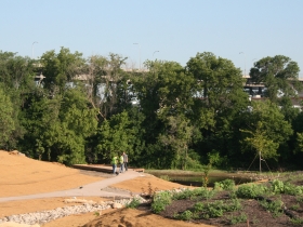 A sidewalk down to the river in Three Bridges Park.