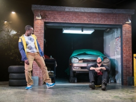 L-R: Andrew Muwonge as Oshoosi Size, Travis A. Knight as Ogun Size