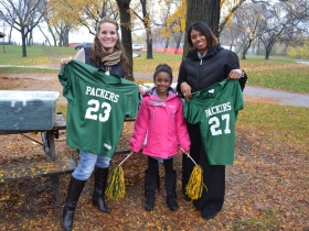 Future cheerleader Ahje Bethley, stands between Journey House volunteer parents Serena Rehka and Amorie Bethley