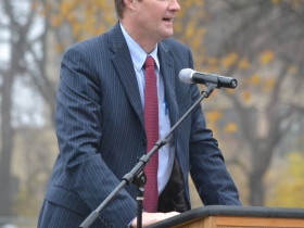 Milwaukee County District Attorney,  John T. Chisholm, playfully challenges the audience to a game of football