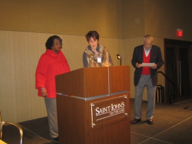 Rep. Gwen Moore (l) gets ready to speak as host Gene Gilbert consults his notes prior to introducing her to the residents of St. John's on the Lake Monday, December 30th, 2013.