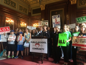 Pictured at the podium is Sandy Whisler from the grassroots group Citizen Advocates for Public Education based in Lake Mills, WI.