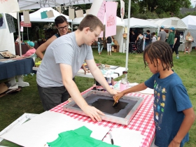 Ashia, from Wauwatosa, enjoyed the hands on print making demonstration by the UWM Print Narrative Forms Club at the Firefly Art Fair children's area