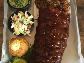 Baby back ribs and pulled pork with coleslaw, creamed spinach, and cornbread