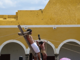 Jesus is raised up on the cross with one of the two criminals in the background
