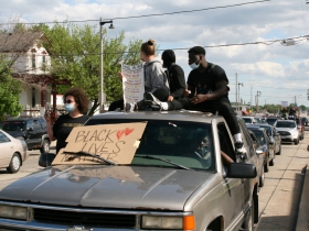 Vehicles Following Marchers