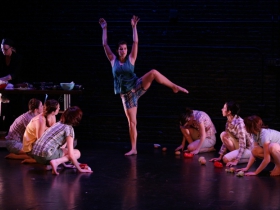 Jennifer Goetzinger cooking in the background, with Jessie Mae Scibek featured among the cast