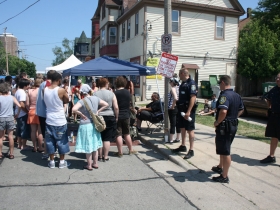 Police Officers and Festival Goers Look On