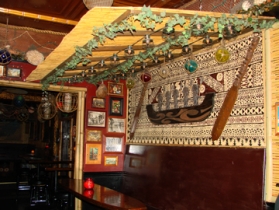 Front seating with tiki art tapa handmade in Fiji and paddlers carved by Hansen.