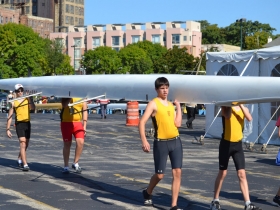 Rowers Carry Their Boat Through Schlitz Park to the Milwaukee River