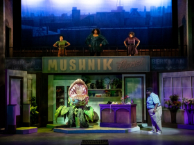 (l. to r.) Kristen Jeter (Chiffon), Raven Dockery (Ronnette), Brandite Reed (Crystal), and Kevin James Sievert (Seymour) in Skylight Music Theatre’s production of Little Shop of Horrors running November 19, 2021 - January 2, 2022. (Editor’s Note: Audrey II Puppeteer - Gabriella Ashlin. Audrey II Voice - Aaron Reese Boseman).