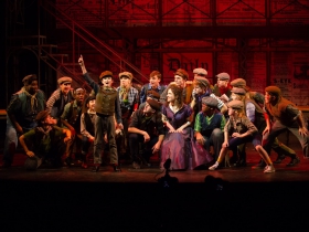 Edward Owczarski (Les, front, standing and pointing) with the cast of Skylight Music Theatre’s production of Disney’s Newsies running November 15 – December 29, 2019. (Note: the role of Les is double cast)