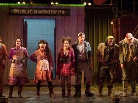 The cast in rehearsal for Skylight Music Theatre’s production of Urinetown, The Musical May 18 – June 10 on the Cabot Theatre stage.