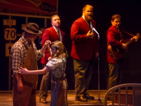 Foreground: Jeff Schaetzke (Father) and Ella Rose Kleefisch (young Violet). Background: Rick Pendzich (Radio Singer), Robby McGhee (Radio Soloist) and Ryan Stajmiger (Radio Singer) in Skylight Music Theatre’s Violet