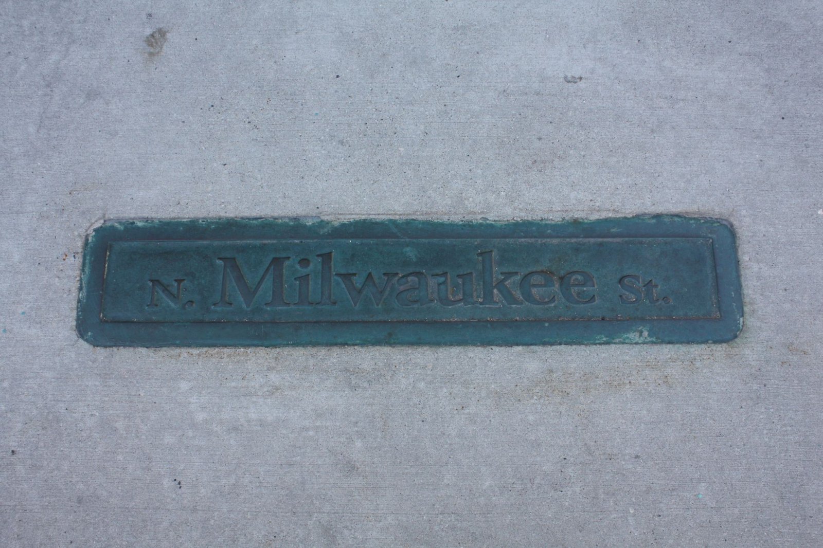 N. Milwaukee St. sign in the sidewalk