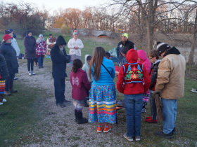 People gather for the Sturgeon Water Walk MKE, warming around the fire