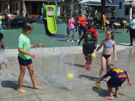 Children play at Columbia Playfield's splash pad on the day of its reopening