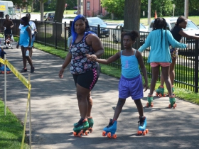 Children rollerskate on Columbia Playfields new walking path on the day of it reopening