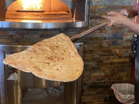 Taboun bread coming out of the oven
