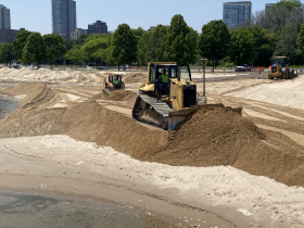 ulldozer loader pushing sand Tuesday, June 20 at McKinley Beach