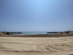 One day later and the sand piles that line the beach are smaller