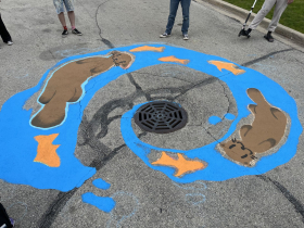Detail of the otter and fish storm drain mural