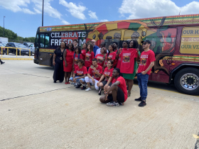 True Skool poses in front of bus