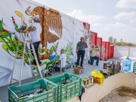 (From Left) Chacho Lopez and Ben Stark add detail to the Mexico flag.