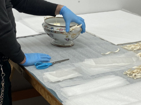 A historic British ceramic terrine is packed for transport at Milwaukee Public Museum