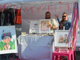 Summer Morrison [R] at her booth with her husband at Frida Fest