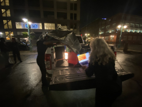Heather Perkins works to project anti-Trump messages on building in Historic Third Ward