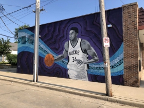 Giannis Antetokounmpo mural by Fred Kaems located at 3600 S. Clement Ave.