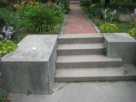 The entry stairs is a nice Prairie touch. It appears it once had a light standard on the left. The Hostas and Hemerocallis are having a good time.