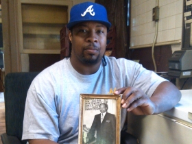 Darnell Ashley holds a photo of his father.