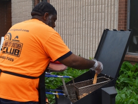 Fish being fried by a Inner City Sportsmen Club member